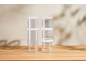 Clear stackable storage containers with white lids on a wooden table.