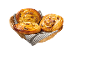 Wicker basket with three golden raisin swirls on a striped cloth.