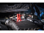 Car jump starter with jumper cables connected to the car battery.