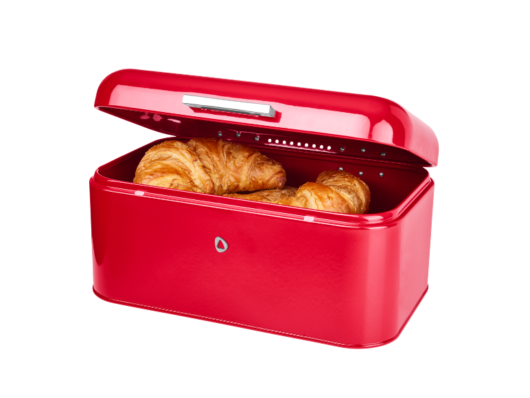 Red bread bin with an open lid and fresh croissants inside.