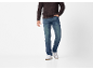 Man in a dark brown sweater and blue jeans.
