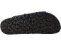 Close-up of the black patterned sole of a sandal.