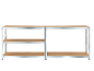 Three-tier metal shelving unit with chipboard shelves on a black background.