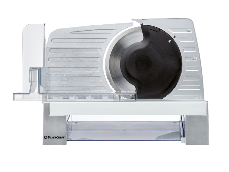 Silver electric slicer with a circular blade and a transparent collection tray.