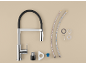 Disassembled kitchen faucet with flexible hose and mounting parts.