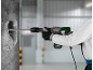 Person using a hammer drill to break concrete, highlighting power tools.