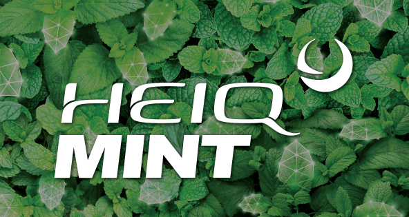 White text «HEIQ MINT» on a background of green mint leaves.