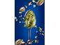 Spoon with pistachio cream and floating pistachios on a blue background.