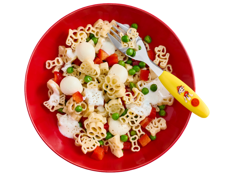 Kids' animal-shaped pasta with peas, bell peppers, and white sauce in a red bowl.