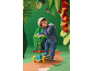 Child with helmet and three-wheeled scooter in a paper jungle environment
