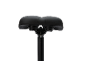 Black bicycle saddle with seat post on a black background