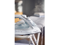 Steam iron on ironing board with steam coming from the iron