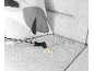 Vacuum cleaner cleaning bread crumbs from a grey sofa with a patterned cushion.