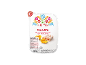 Rice, turkey, and peach salad in white packaging with a floral pattern.