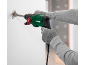 Man using a rotary hammer to chisel a wall.