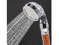 Shower head with water filter and mineral granules, with water flowing out.