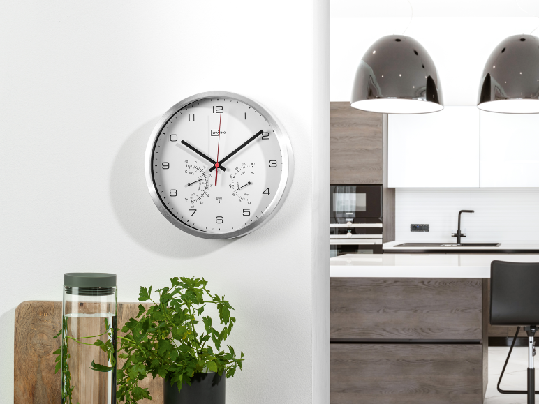 Wall clock with thermometer and hygrometer in a modern kitchen.