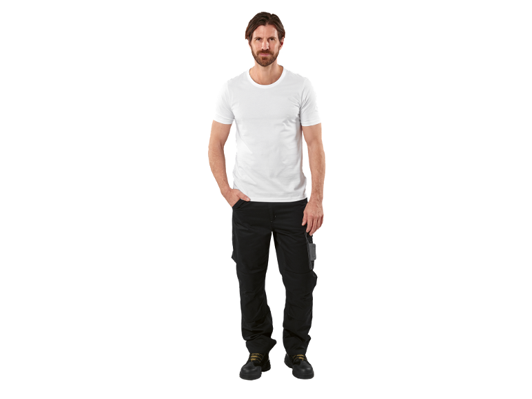Man in white t-shirt and black work trousers with safety boots.