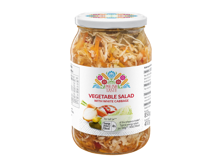 Vegetable salad with white cabbage in a glass jar, with a folk pattern on the label.