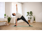 Man in yoga pose with CRIVIT yoga socks on a mat.