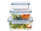 Stackable glass food containers with cucumbers, carrots, and salad