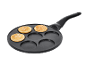 Pancake pan with three golden-brown pancakes and three empty spaces.