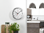 Wall clock with thermometer and hygrometer in a modern kitchen.