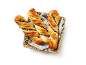 Three chocolate puff pastry twists in a wicker basket with a striped cloth.