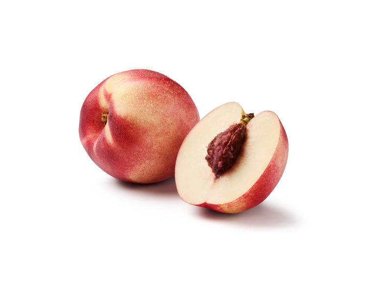 Whole nectarine and half a nectarine with a pit on a white background.