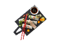 Fresh spring rolls with dipping sauce, red chopsticks, and garnishes on a dark board.