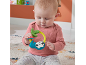 Baby playing with a brightly colored sloth rattle.