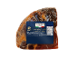 Vacuum-packed prosciutto crudo with a blue label showing nutritional information.