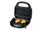 Electric grill with two pieces of grilled chicken on a black background.