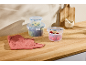 Silvercrest food storage containers with click closure, filled with salad, lime, and tomatoes on a wooden counter.
