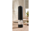 Electric salt grinder on a kitchen countertop with garlic.