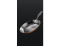 An elegant copper and steel frying pan with a long handle, against a dark background.