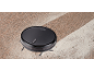 Robot vacuum cleaner cleaning a dusty surface, leaving a clean path behind.