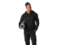 Man in black tracksuit holding a rolled-up yoga mat.