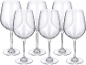 Six transparent wine glasses on a black background.