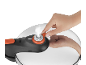 Hand adjusting the valve of a pressure cooker with steam escaping.