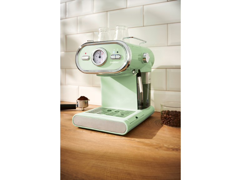 Mint green espresso machine with a temperature gauge and cups on top.