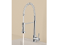 Chrome kitchen faucet with pull-down spray head and water running into a sink.
