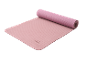 Pink exercise mat with a rolled-up part and grid texture.