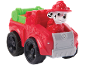 Red fire truck toy with a Dalmatian puppy at the wheel.