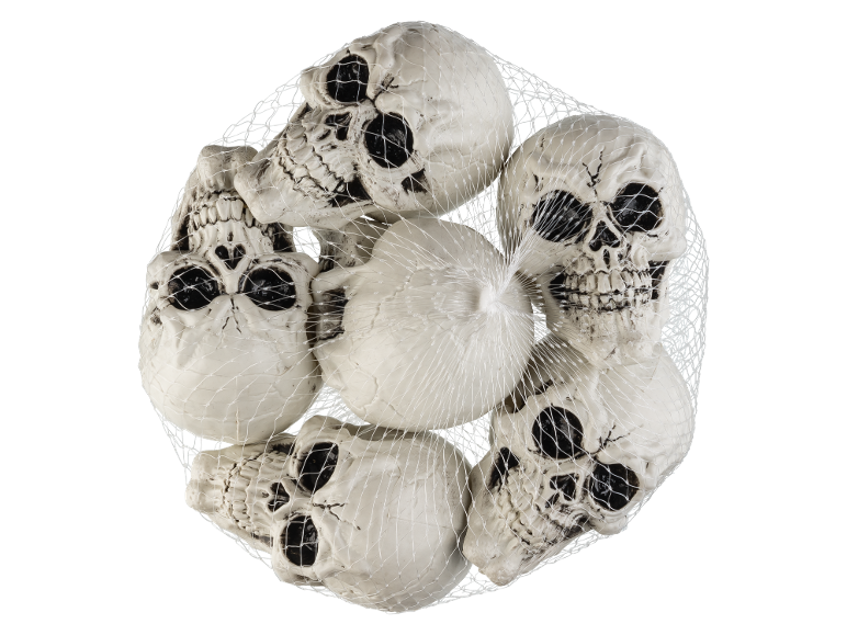 A net full of white, plastic skulls on a black background, ideal for Halloween.