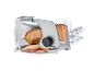 Silver electric food slicer with a loaf of bread and sliced bread on a tray