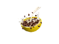 Milk pouring into a yellow bowl of chocolate cereal, creating splashes.