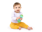 Baby in a purple top and yellow trousers playing with a green rattle.