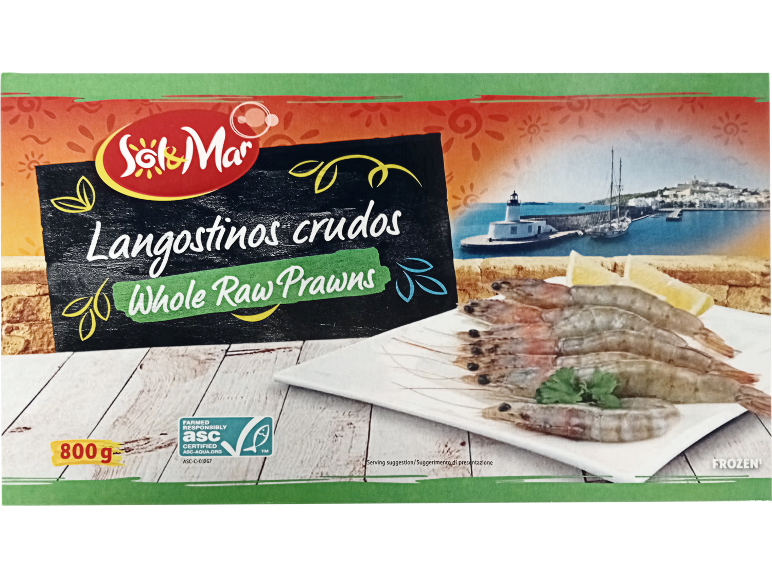 Box of frozen whole raw prawns with a Mediterranean port in the background.