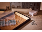 Organizer with screws and hooks, wooden board with hooks, keys, and paper blocks on a wooden table.